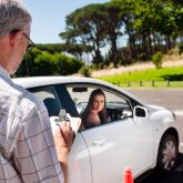 Learner driver girl with intstructor taking lessons